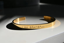 Cargar imagen en el visor de la galería, &quot;I AM GRATEFUL&quot; Affirmation engraved in gold tarnish resistant cuffed bracelet (bendable)
